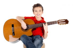 handsome happy boy is playing acoustic guitar isolated white 186202 2931 آموزش آنلاین موسیقی در آموزشگاه سازنو